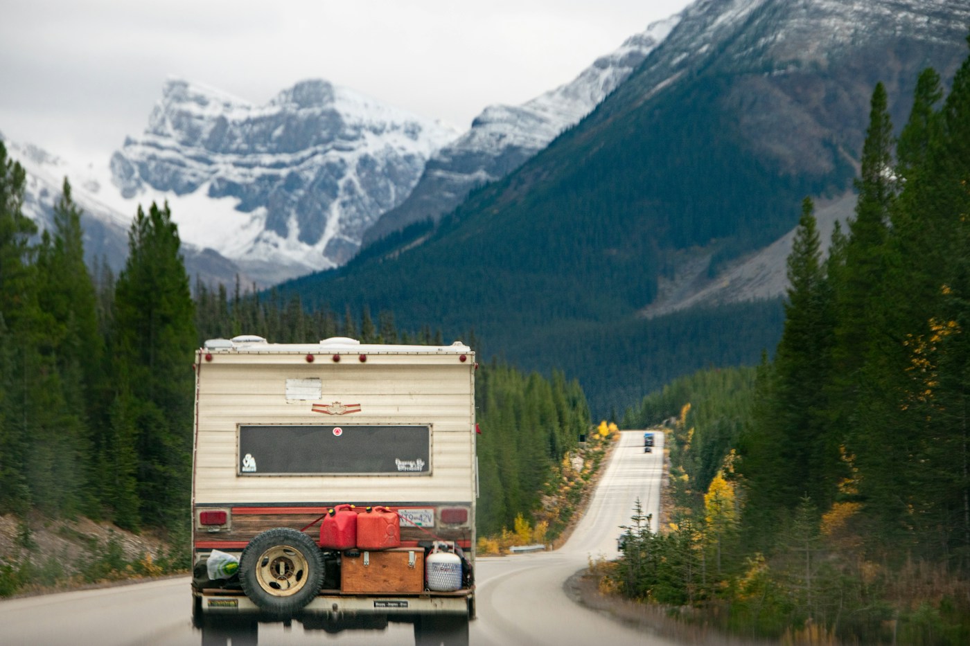A camper heading up a mountain road toward the Canadian Rockies